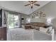 Bright living room with vaulted ceilings, ceiling fan, a brown sectional, and a sliding glass door at 933 Curlew Ln, Greenwood, IN 46143