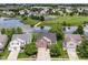 Aerial view of a brick two-story home in a neighborhood with a pond and community park at 9358 W Rising Sun Dr, Pendleton, IN 46064