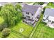 Aerial view of a backyard featuring a fire pit, a deck, and mature landscaping at 9358 W Rising Sun Dr, Pendleton, IN 46064