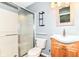 Bright bathroom featuring a walk-in shower, toilet, and vanity with wood cabinets at 9358 W Rising Sun Dr, Pendleton, IN 46064