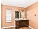 Bathroom featuring a double sink vanity, framed mirror, and wood-look flooring at 9358 W Rising Sun Dr, Pendleton, IN 46064
