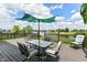 Outdoor deck with seating overlooking a pond and walking path at 9358 W Rising Sun Dr, Pendleton, IN 46064