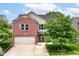 Charming two-story home with a brick facade, attached garage, and well-maintained lawn at 9358 W Rising Sun Dr, Pendleton, IN 46064
