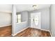 View of the front door and foyer with gray walls and wood-look flooring at 9358 W Rising Sun Dr, Pendleton, IN 46064