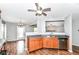 Kitchen showcasing wood cabinets, laminate countertops, stainless steel appliances and wood-look flooring at 9358 W Rising Sun Dr, Pendleton, IN 46064