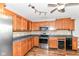 Kitchen featuring wood cabinets, stainless steel appliances, and laminate countertops at 9358 W Rising Sun Dr, Pendleton, IN 46064