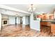 Open living space featuring wood floors, a fireplace, and an open view into the kitchen at 9358 W Rising Sun Dr, Pendleton, IN 46064