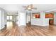 Spacious living room featuring wood floors, ceiling fan, and an open view to the kitchen at 9358 W Rising Sun Dr, Pendleton, IN 46064