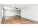 Open-concept living room featuring wood floors, neutral paint, and a ceiling fan at 9358 W Rising Sun Dr, Pendleton, IN 46064