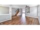 Spacious living room with wood-look floors, gray walls, and staircase at 9358 W Rising Sun Dr, Pendleton, IN 46064
