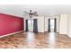 Bright living room with laminate wood floors, neutral walls, and three large windows at 9358 W Rising Sun Dr, Pendleton, IN 46064
