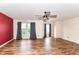 Open living space with two windows, neutral walls, and wood-look flooring at 9358 W Rising Sun Dr, Pendleton, IN 46064
