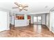 Open concept living area with wood floors, ceiling fan, and an eat-in kitchen visible at 9358 W Rising Sun Dr, Pendleton, IN 46064
