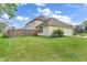 Home's back yard features a fenced in area with a large lawn and mature landscaping at 9754 Bradford Knoll Dr, Fishers, IN 46037