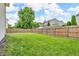 Home's back yard features a large lawn, mature trees and a fenced in area at 9754 Bradford Knoll Dr, Fishers, IN 46037