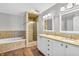 A luxurious bathroom with a jacuzzi tub, glass shower, granite countertops, and double sinks at 9754 Bradford Knoll Dr, Fishers, IN 46037