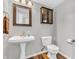 Charming bathroom features a pedestal sink, modern fixtures, and a decorative mirror at 9754 Bradford Knoll Dr, Fishers, IN 46037