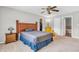 A well-lit bedroom with neutral walls, ceiling fan, an ample closet and adjacent bathroom at 9754 Bradford Knoll Dr, Fishers, IN 46037