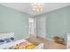 A charming bedroom with green walls, themed light fixture, and a cozy rug at 9754 Bradford Knoll Dr, Fishers, IN 46037