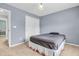 Cozy bedroom featuring neutral carpet, pastel blue walls, and a double door closet at 9754 Bradford Knoll Dr, Fishers, IN 46037