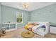 A charming bedroom with green walls, themed light fixture, and a cozy rug at 9754 Bradford Knoll Dr, Fishers, IN 46037