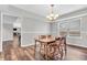 Cozy dining room features a charming wooden table and chairs, perfect for Gathering meals under a modern chandelier at 9754 Bradford Knoll Dr, Fishers, IN 46037