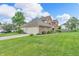 Charming home featuring brick and siding exterior, large windows, and a well-kept lawn at 9754 Bradford Knoll Dr, Fishers, IN 46037