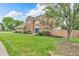 Beautiful two-story home featuring a brick facade, manicured lawn and lush landscaping at 9754 Bradford Knoll Dr, Fishers, IN 46037