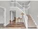Inviting foyer featuring a staircase, stylish lighting, and rich wood-look flooring at 9754 Bradford Knoll Dr, Fishers, IN 46037