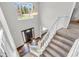 Grand two-story foyer with a large window, hardwood floors, and an elegant staircase at 9754 Bradford Knoll Dr, Fishers, IN 46037