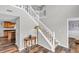 Spacious foyer with a staircase, complemented by unique wood-look flooring at 9754 Bradford Knoll Dr, Fishers, IN 46037