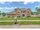 Charming two-story brick home with a well-manicured lawn and a bright blue front door at 9754 Bradford Knoll Dr, Fishers, IN 46037
