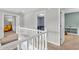 Upstairs hallway with neutral decor, leading to various rooms in the house at 9754 Bradford Knoll Dr, Fishers, IN 46037