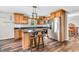 Modern kitchen boasts sleek stainless steel appliances, wood cabinetry, and a practical island with barstool seating at 9754 Bradford Knoll Dr, Fishers, IN 46037