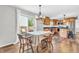 Bright kitchen features wood cabinets, stainless appliances, granite counters, and wood flooring at 9754 Bradford Knoll Dr, Fishers, IN 46037