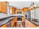 Well-appointed kitchen includes stainless steel appliances, granite countertops, and classic wood cabinets, blending style and function at 9754 Bradford Knoll Dr, Fishers, IN 46037