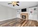 Spacious living room features a stone fireplace with built-in shelving, ceiling fan, and recessed lights at 9754 Bradford Knoll Dr, Fishers, IN 46037
