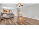 Comfortable living room with wood floors, large windows, and a view into the dining room at 9754 Bradford Knoll Dr, Fishers, IN 46037