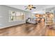 Open floor plan living room with wood floors, large windows, and a view into the dining room at 9754 Bradford Knoll Dr, Fishers, IN 46037