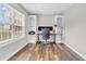 Bright office featuring built-in shelves, a modern desk setup, and ample natural light at 9754 Bradford Knoll Dr, Fishers, IN 46037