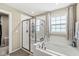 Bright bathroom with a glass shower, soaking tub, and a window letting in natural light at , Brownsburg, IN 46112
