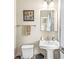 Well-lit bathroom featuring a pedestal sink, framed art, and decorative accents at , Brownsburg, IN 46112