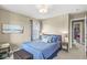 Comfortable bedroom with a blue comforter, accent pillows, and views from the bright window at , Brownsburg, IN 46112