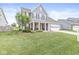 Inviting two-story home showcasing a manicured lawn, classic shutters, and a welcoming front porch at , Brownsburg, IN 46112