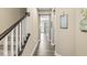 Hallway featuring wood floors leading to a bright living area and staircase at , Brownsburg, IN 46112