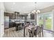 Stylish kitchen with dark cabinetry, island seating, and adjacent dining area at , Brownsburg, IN 46112