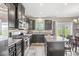 Spacious kitchen with stainless steel appliances, dark cabinetry, island, and a view to the dining room at , Brownsburg, IN 46112