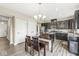 Open kitchen and dining area with dark cabinets and stainless steel appliances at , Brownsburg, IN 46112