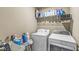 Functional laundry room with modern washer and dryer, and ample shelving for storage at , Brownsburg, IN 46112