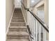 Carpeted staircase with a dark wood and white railing leading to the upper level at , Brownsburg, IN 46112